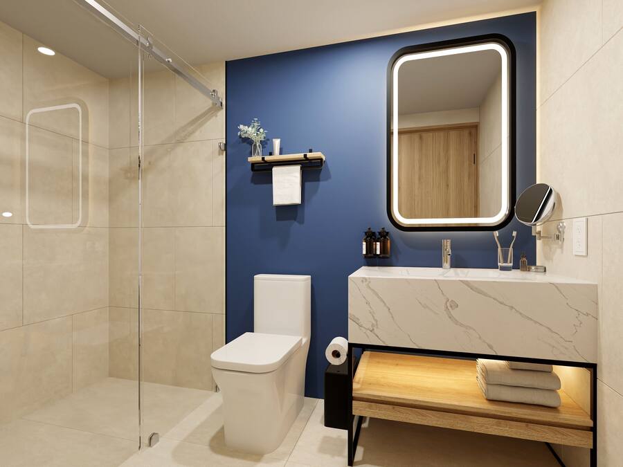 Un baño moderno con inodoro, lavamanos, espejo y ducha.