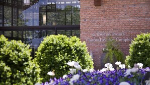 A brick building with a plaque reading "Mr. & Mrs. John W. Wyatt Jr. Visitors Pavilion Complex".