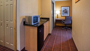 A compact hotel room with a kitchenette, a desk, and a chair. - Holiday Inn Express Hotel & Suites Brainerd-Baxter by IHG (Brainerd)