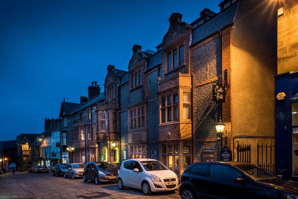 A row of historic buildings with a sign for "Cottage Hotel" on the right. - The Castle Hotel, Conwy, North Wales (Conwy)