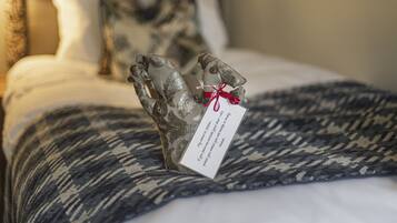 A bed with a patterned blanket and a decorative pillow.