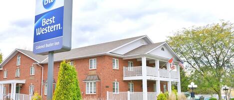 A Best Western hotel with a brick facade, multiple balconies, and a well-maintained lawn.