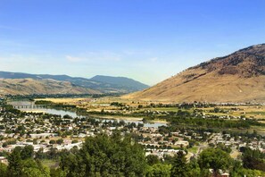 A town with a river, mountains, and a bridge.