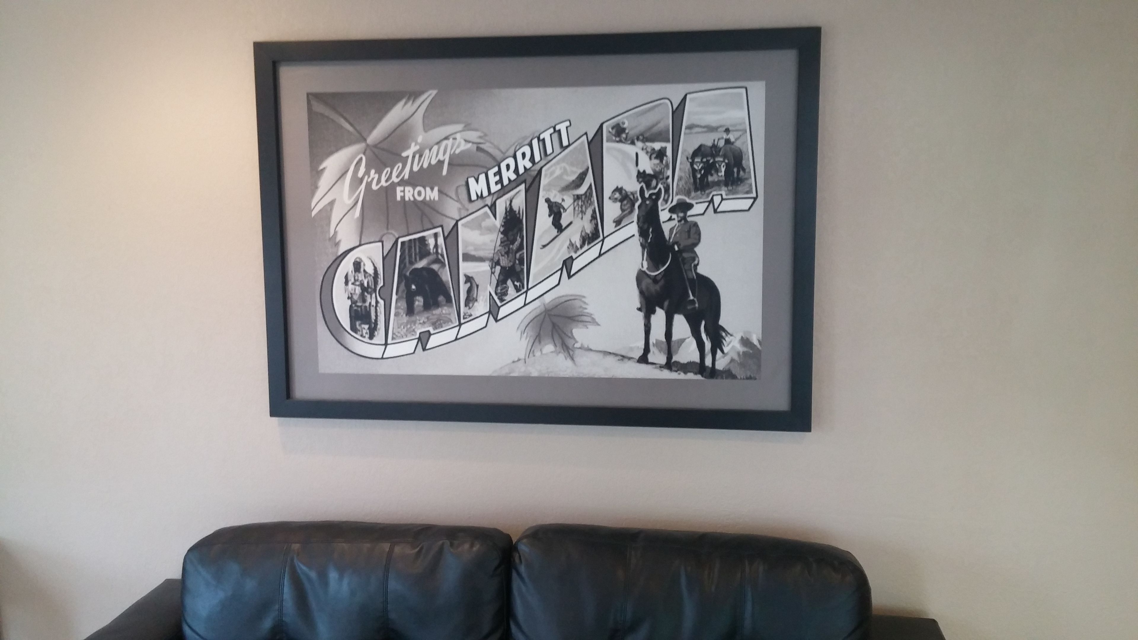A framed collage with the text "Greeting from Merritt" and images of a horse and rider.