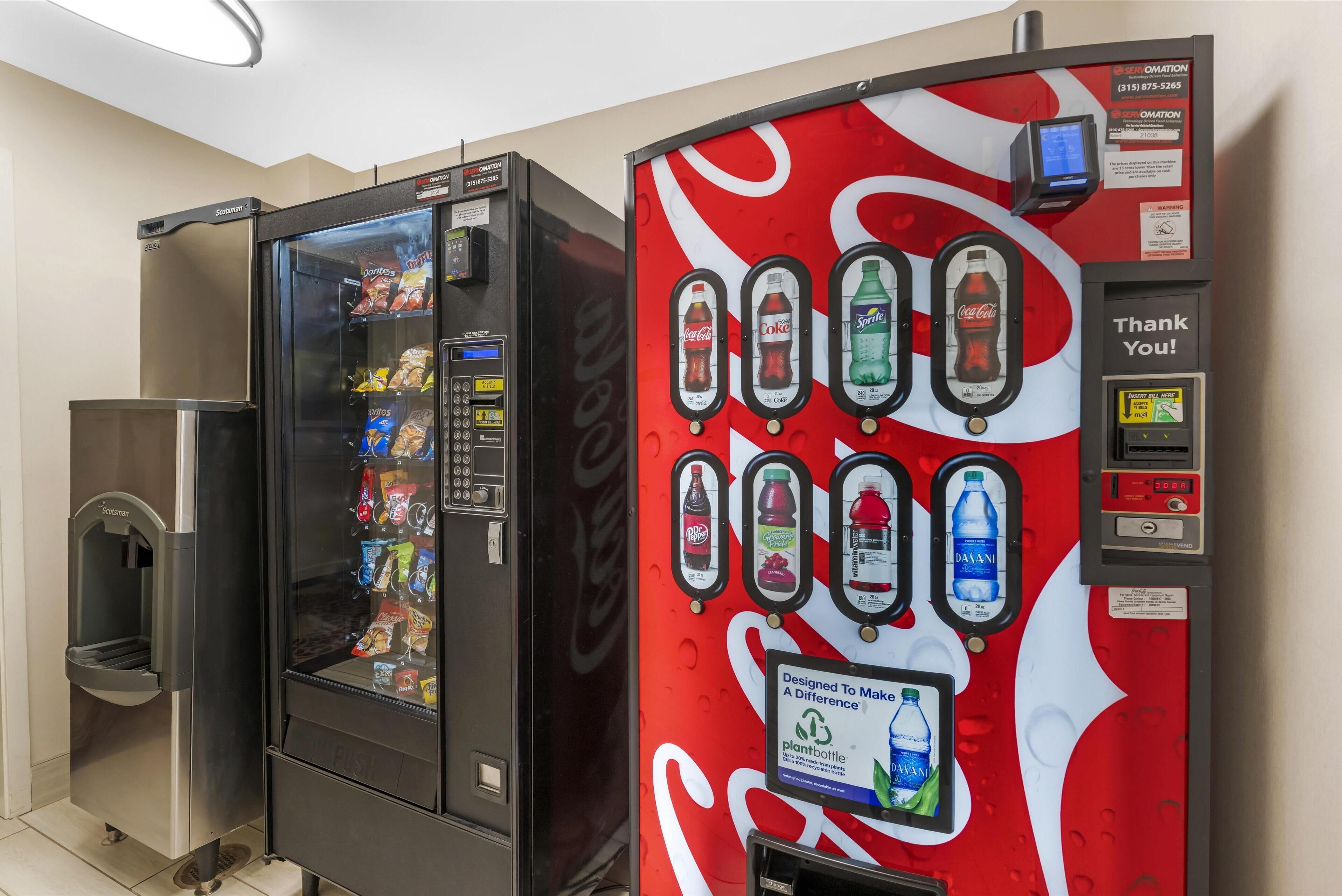 A vending machine with a Coca-Cola logo and a water dispenser.
