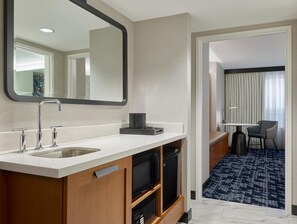 A modern hotel bathroom with a sink, mirror, and a television. - Embassy Suites by Hilton Washington D.C. – Convention Center (Washington)