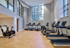 A gym with various cardio machines, including treadmills and stationary bikes, arranged in rows. - Embassy Suites by Hilton Washington D.C. – Convention Center (Washington)