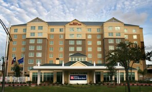 A large, multi-story hotel with a prominent sign reading "Hilton Garden Inn." - Hilton Garden Inn Houston/Galleria Area (Houston)