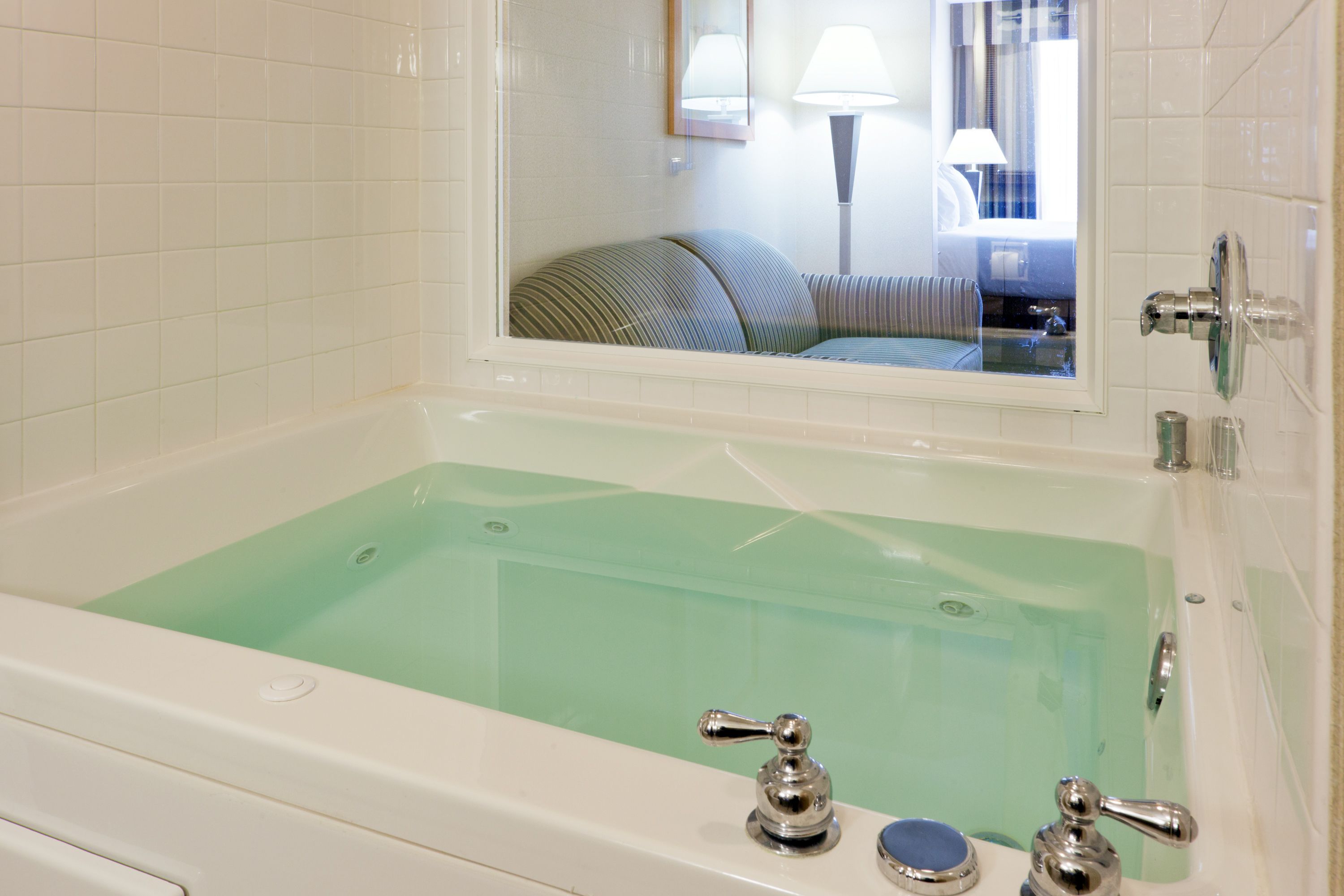 suite, 1 king bed, jetted tub | in-room safe, desk, iron/ironing board, free cots/infant beds