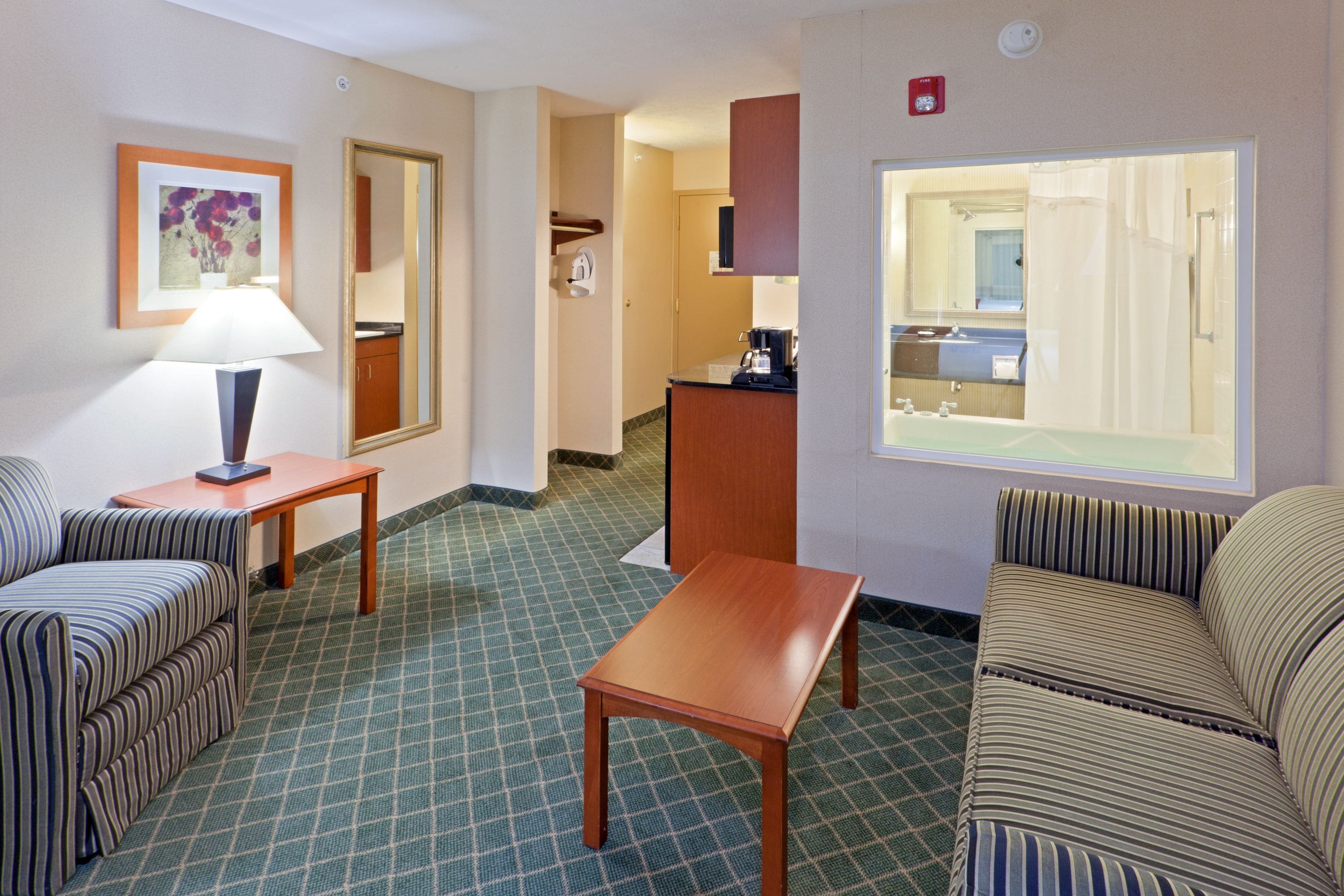 suite, 1 king bed, jetted tub | in-room safe, desk, iron/ironing board, free cots/infant beds