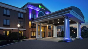 A Holiday Inn Express building with a covered entrance, large windows, and a well-lit facade. - Holiday Inn Express & Suites Kent - University Area by IHG (Kent)