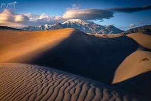 A desert landscape with sand dunes and a mountain in the background. - Holiday Inn Express & Suites Alamosa by IHG (Alamosa)