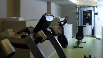 A gym with treadmills, a stationary bike, and a weight bench.
