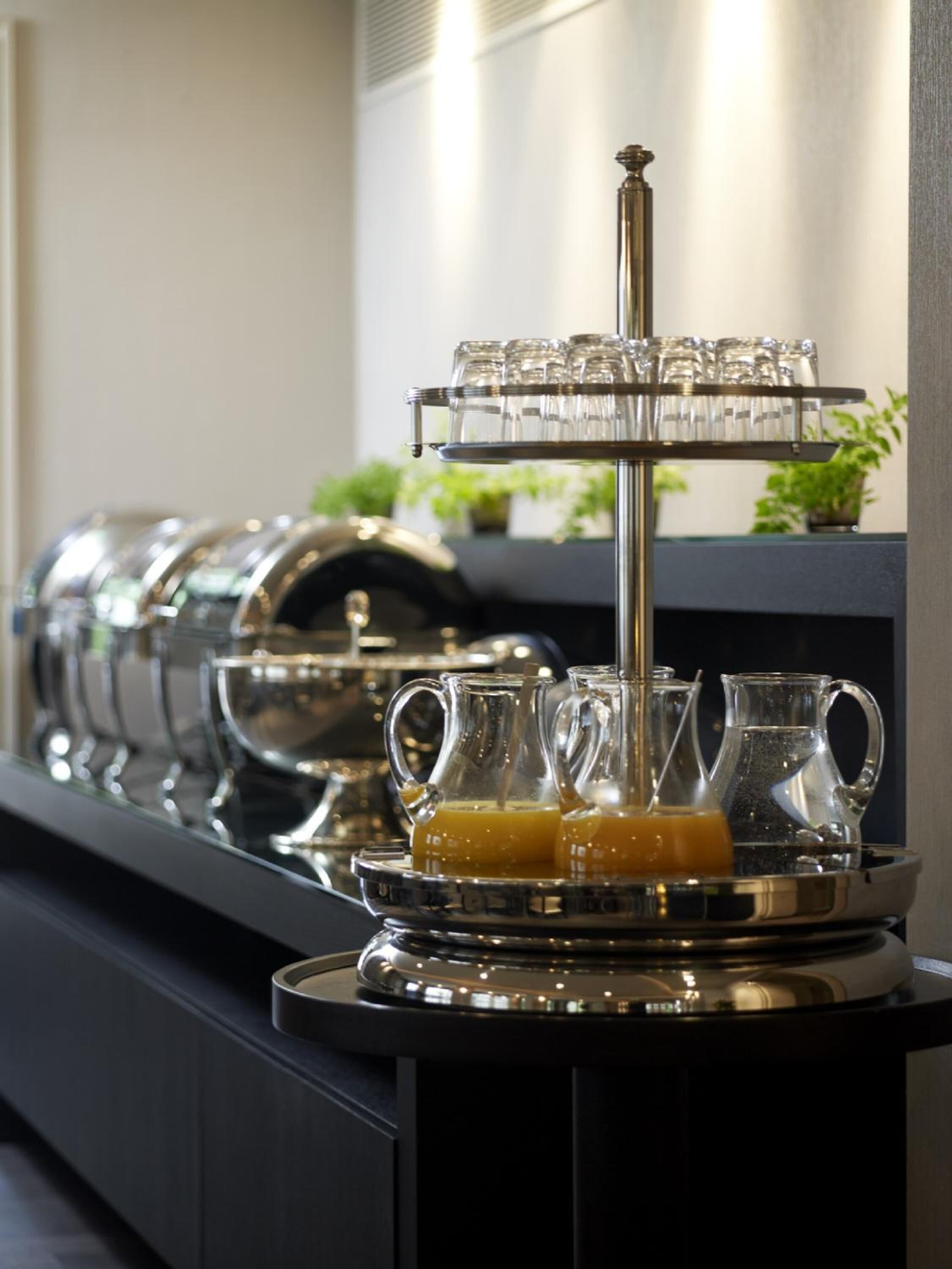 A buffet setup with multiple glassware and pitchers, likely for beverages.