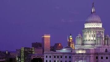 A cityscape with a prominent domed building, likely a government or historical structure, with surrounding modern high-rise buildings.