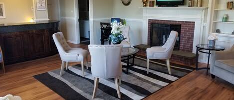 A living room with a fireplace, a television, and a reception desk.