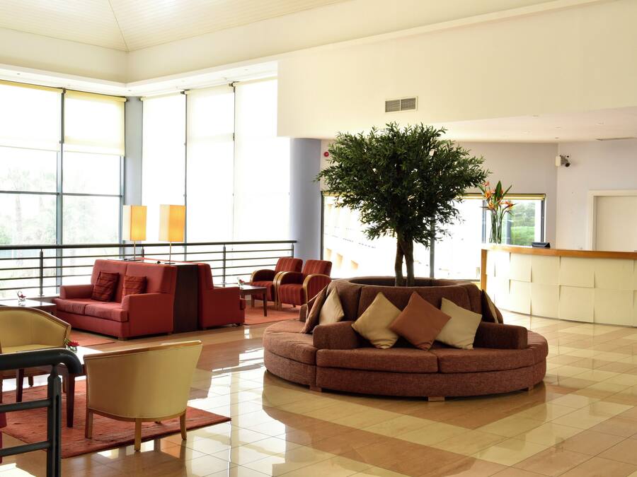 A spacious lobby with a large window, a reception desk, and a variety of seating options.