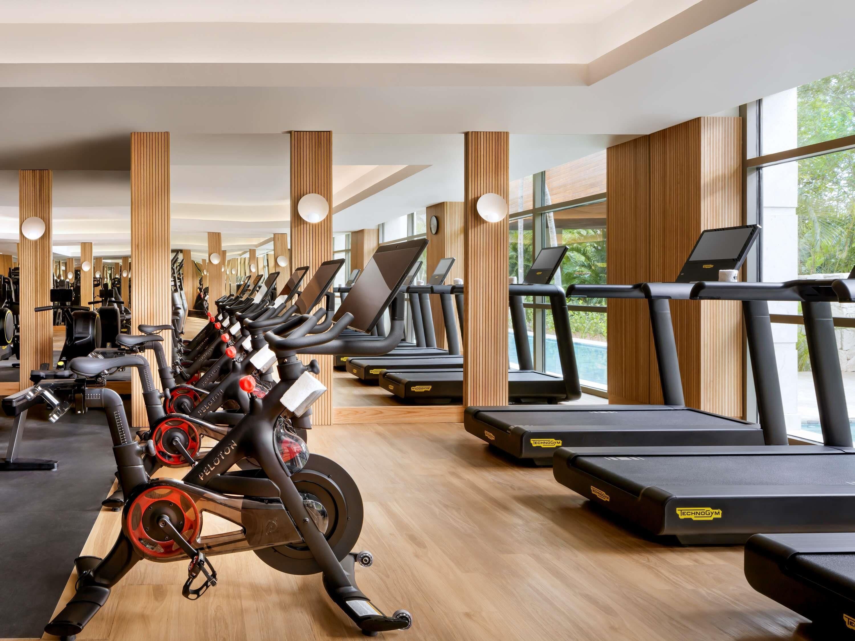 A gym with stationary bikes, treadmills, and exercise equipment.