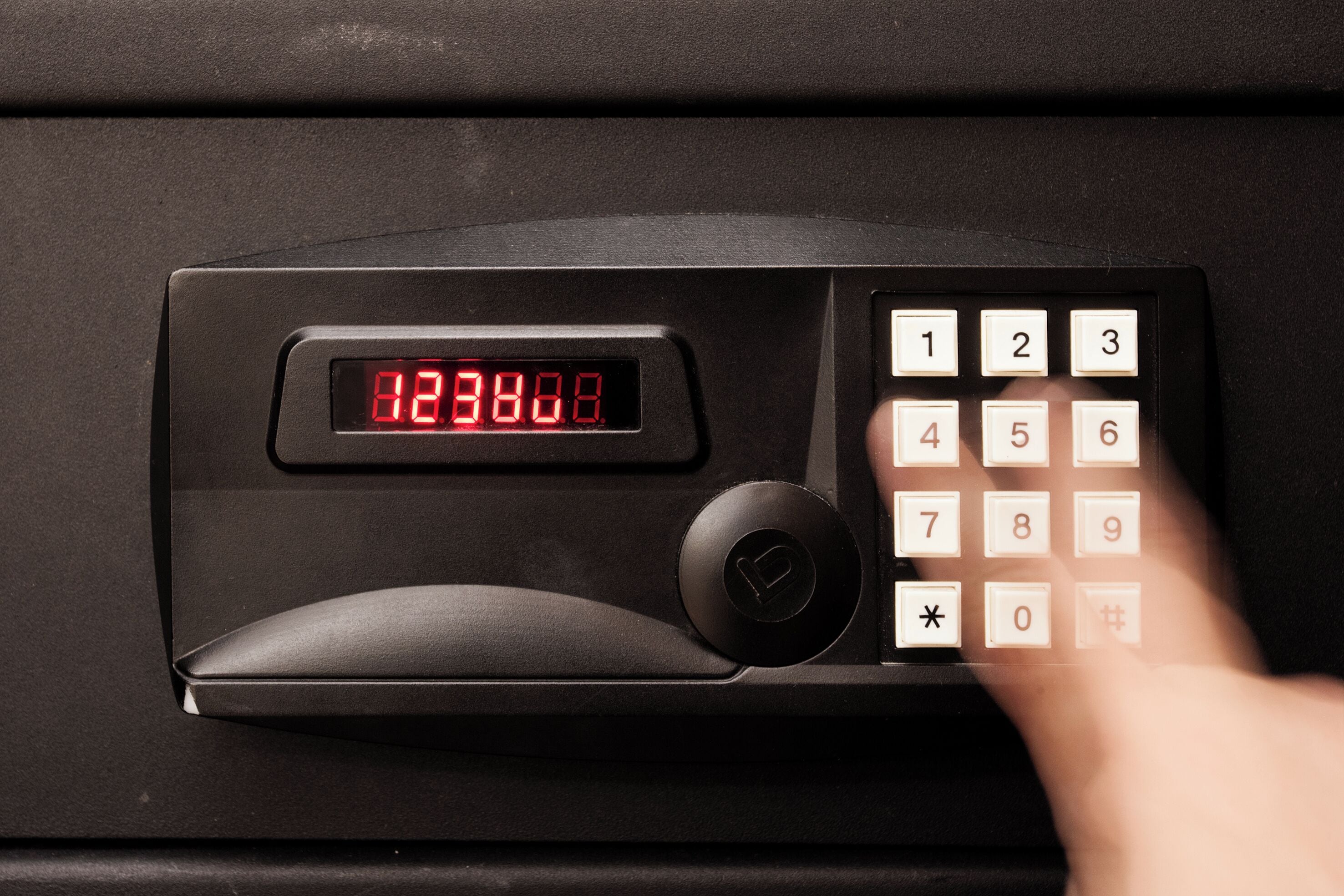 A car key fob with a digital display and a numeric keypad.