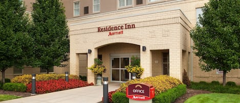 A brick building with a sign reading "Residence Inn Marriott" and a mailbox labeled "Office Marriott".
