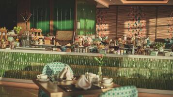 A restaurant with a green-tiled wall, wooden furniture, and various food and drink items on display.