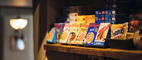 A shelf with various cereal boxes.