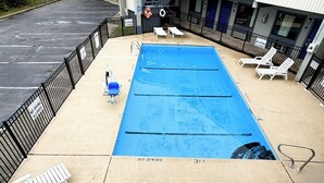 A swimming pool with no diving allowed, surrounded by lounge chairs and a fence. - Rodeway Inn & Suites Plymouth Hwy 64 (Plymouth)