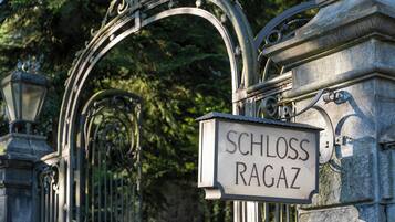 A wrought iron gate with a sign reading "SCHLOSS RAGAZ."