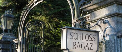 A wrought iron gate with a sign reading "SCHLOSS RAGAZ."