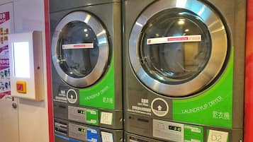 Two laundry machines with digital displays and instructions in multiple languages.