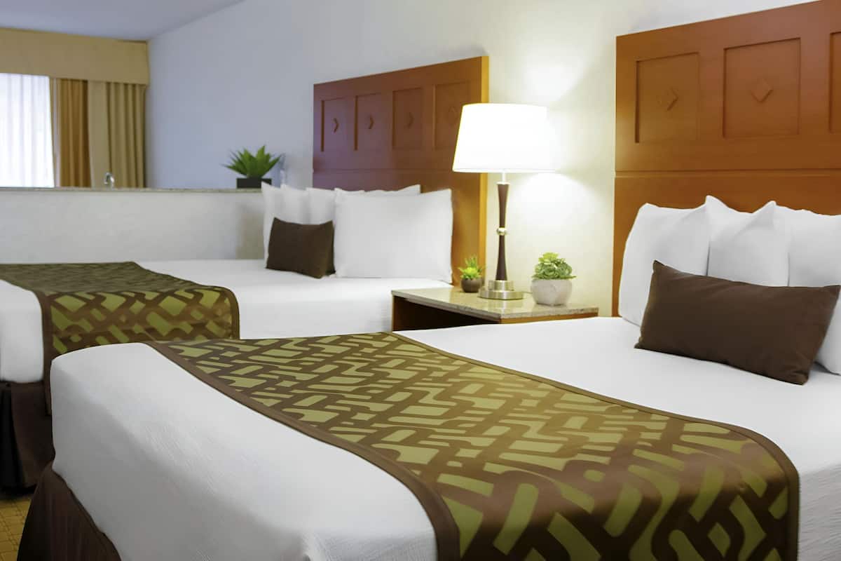 deluxe suite, 2 queen beds, jetted tub | 1 bedroom, in-room safe, desk, blackout curtains