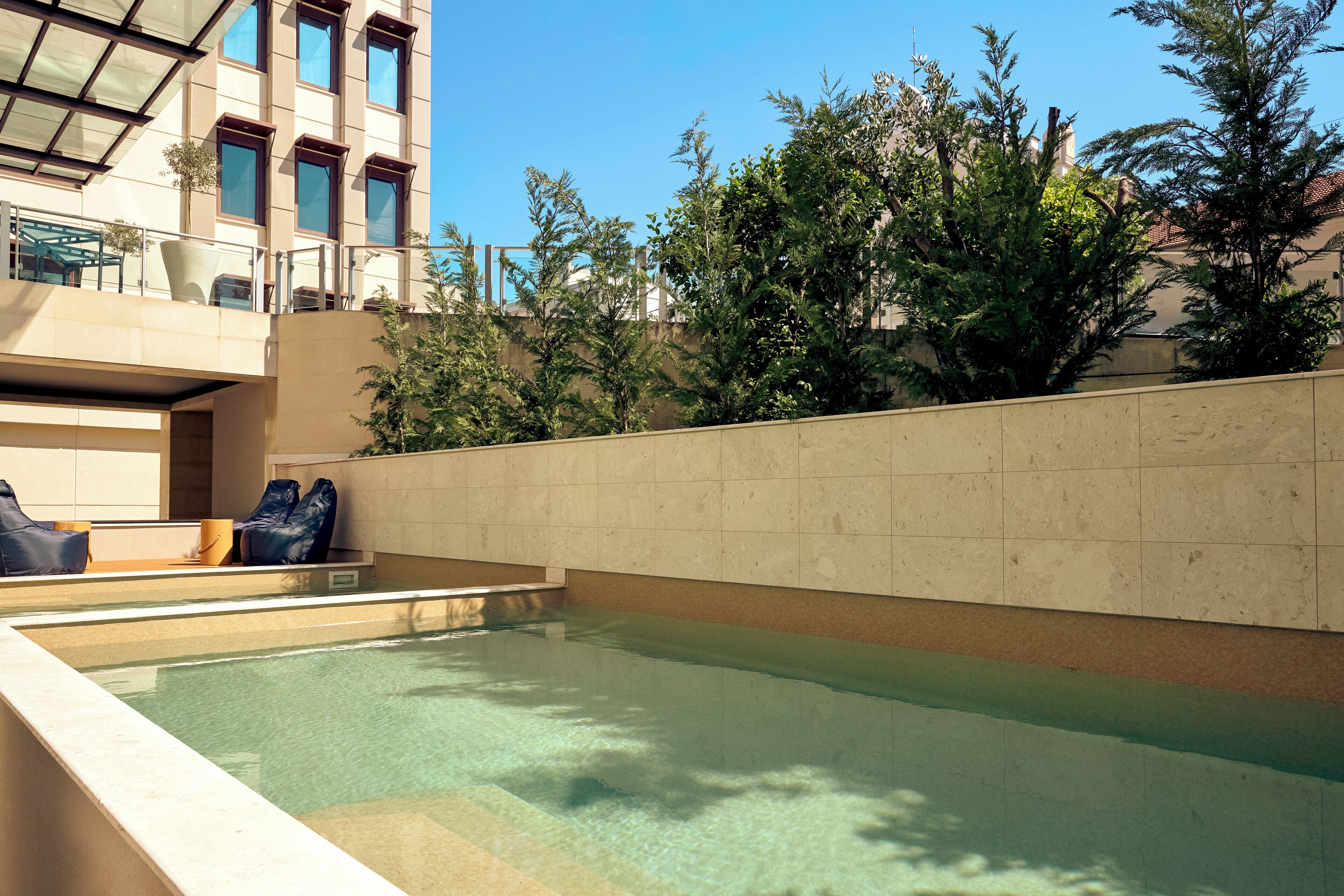 A swimming pool with a clear view of the surrounding buildings and trees.
