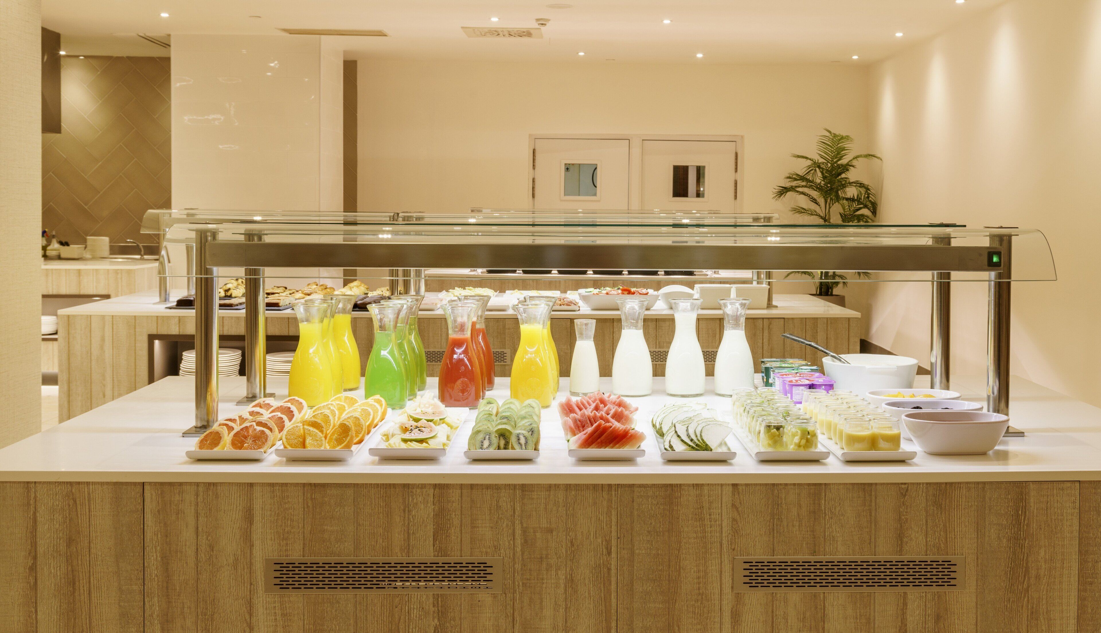 A buffet with various food items and beverages.