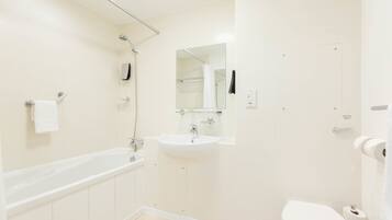 A modern bathroom with a bathtub, sink, and toilet.