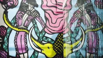 A colorful mural with abstract figures and patterns.