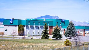 A Helena Inn building with a green roof, multiple windows, and a signboard.
