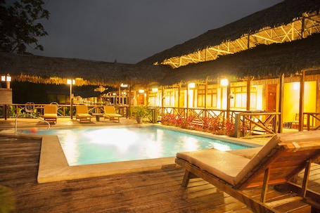 Outdoor pool, pool loungers. Heliconia Amazon River Lodge