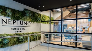A hotel interior with a wall labeled "NEPTUNO HOTEL & SPA" and a visible "GASTRO & COCKTAIL BAR" area. - Neptuno Hotel & SPA (Calella)