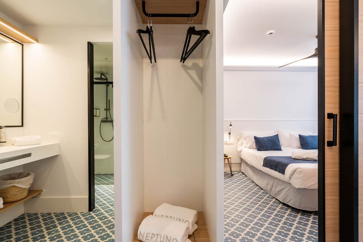 A modern bathroom with a shower, a sink, and a mirror.