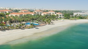 A resort with multiple buildings, a sandy beach, and a pool area. - Al Raha Beach Resort & Spa (Abu Dhabi)