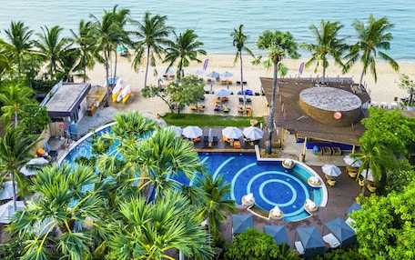 A resort with a pool, beach, and ocean view.