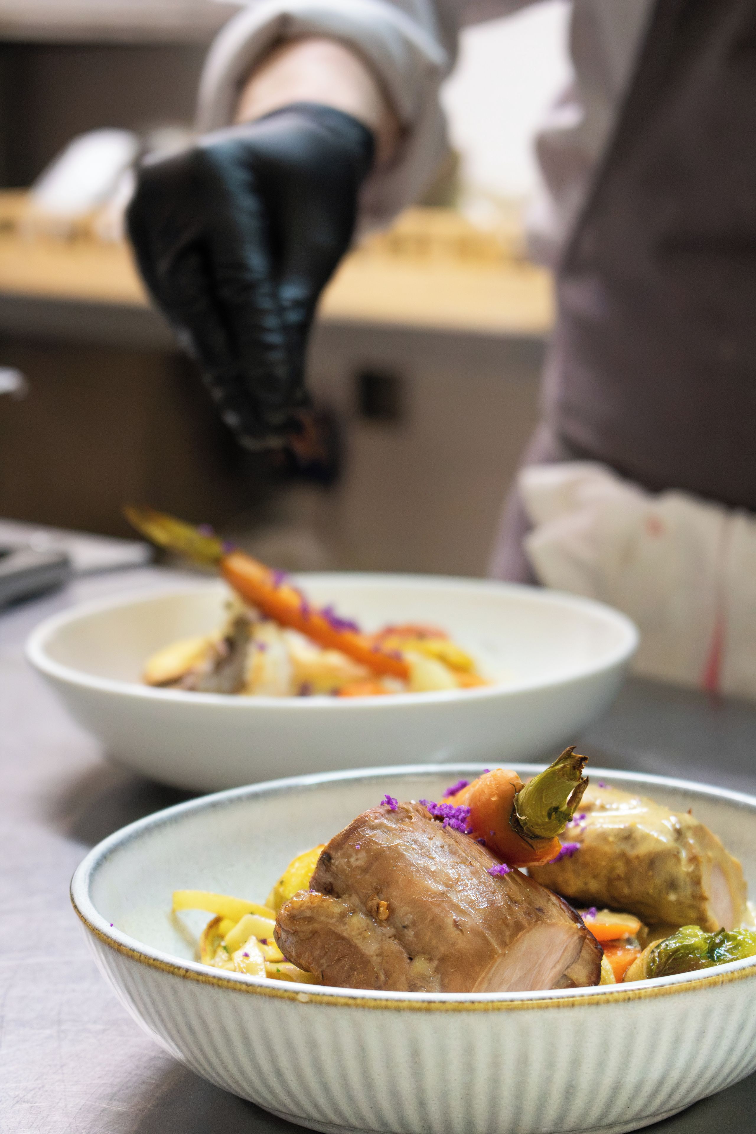A chef preparing food in a kitchen.