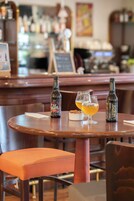 Un bar con dos botellas y dos vasos sobre una mesa de madera.