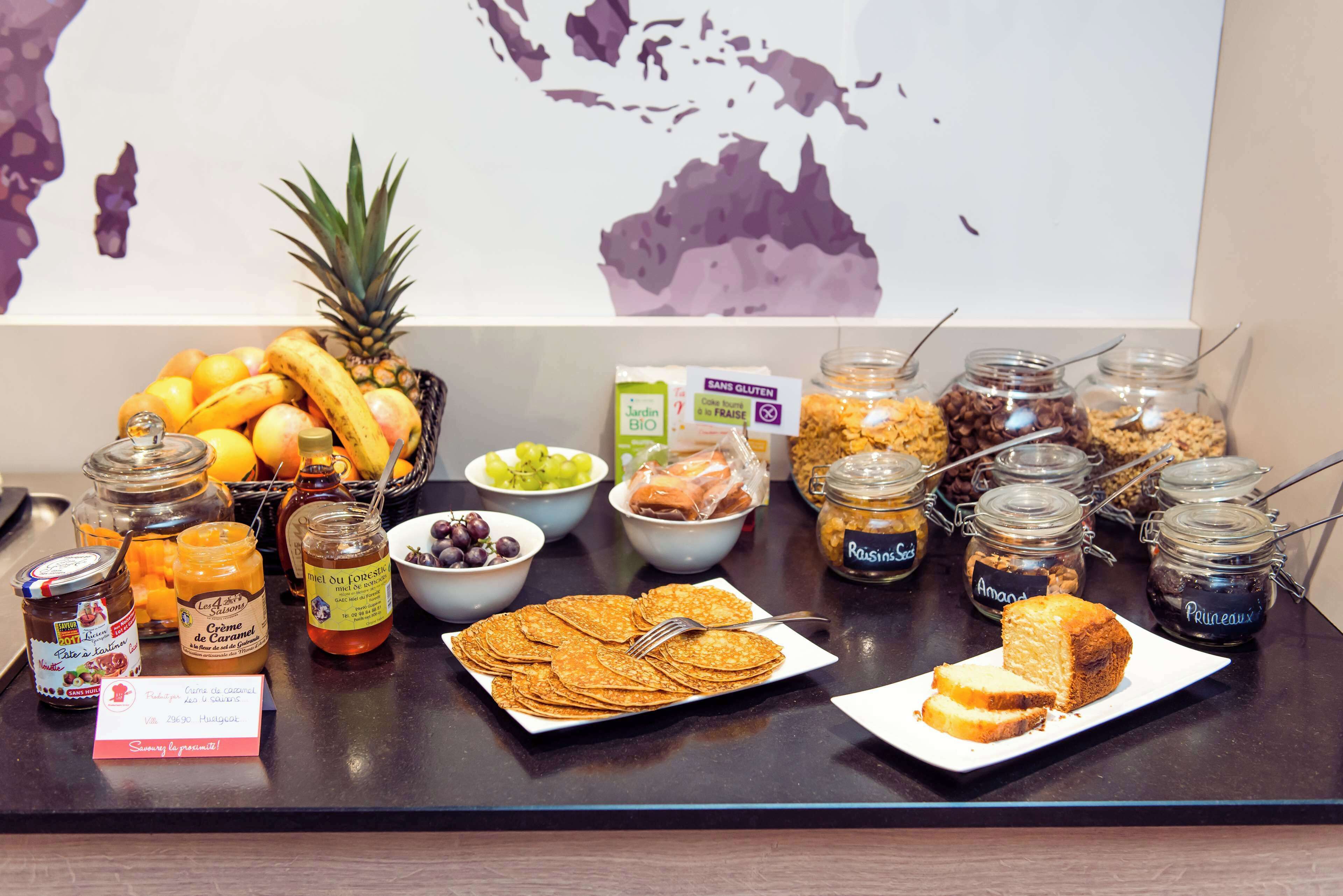 A breakfast buffet with various food items and condiments.