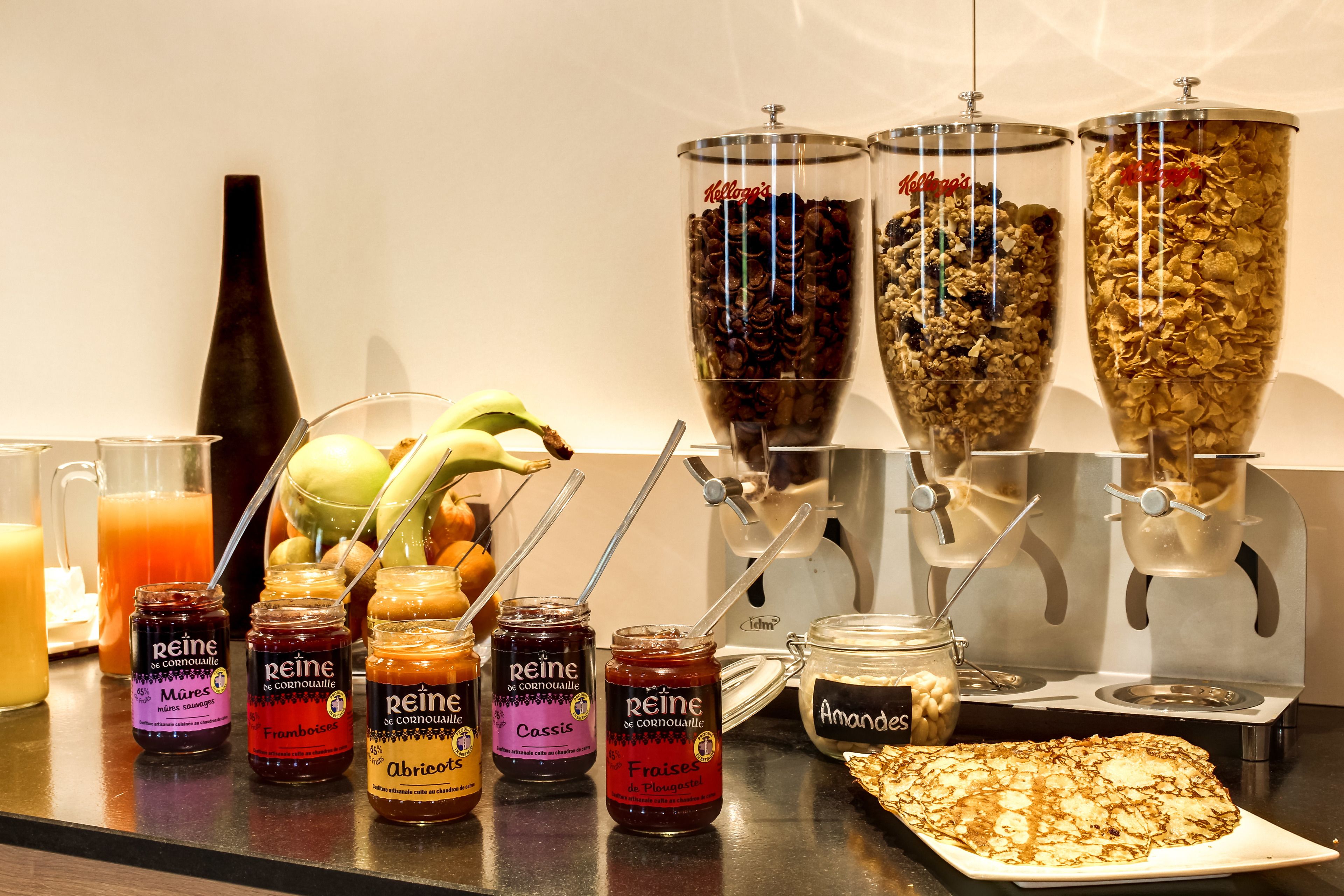 A breakfast buffet with various food items and condiments.