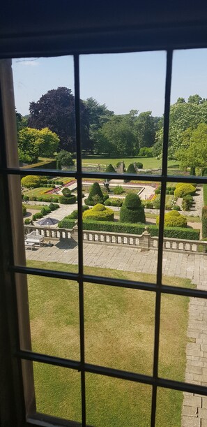 A view of a well-maintained garden with manicured lawns, hedges, and flower beds. - Fanhams Hall Hotel (Ware)