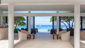 A spacious lounge area with a view of the beach and ocean. - The Racha (Ko Racha Yai)