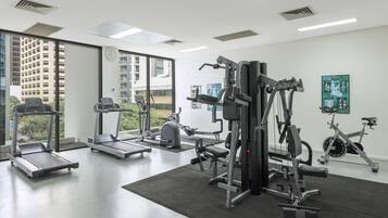 A gym with treadmills, a weight machine, and a stationary bike.