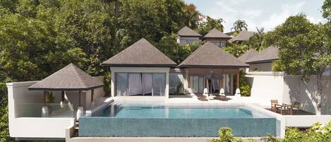 A modern resort with a central swimming pool, multiple lounge areas with umbrellas, and a lush green backdrop.