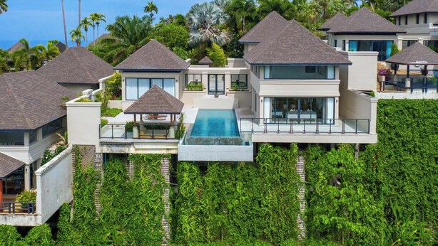 A modern resort with multiple villas, a central pool, and lush greenery. - The Pavilions Phuket (Choeng Thale)